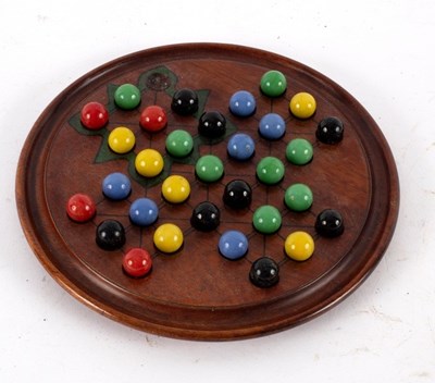 Lot 418 - A solitaire board, the coloured marbles for...