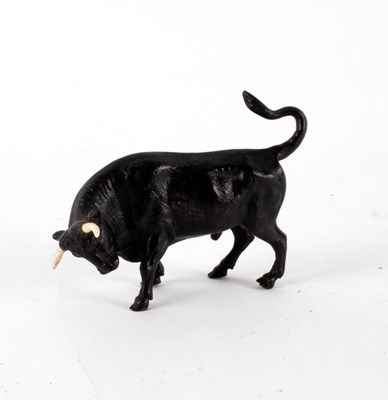 Lot 420 - A bronze figure of a charging bull, 11cm long