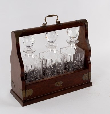 Lot 423 - An Edwardian oak cased tantalus fitted three...