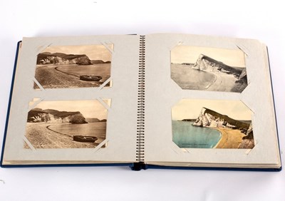 Lot 427 - An early 20th Century postcard album of...