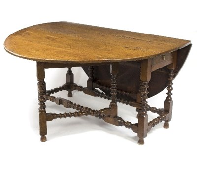 Lot 522 - An 18th Century oak two-flap table, on bobbin...