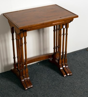 Lot 525 - A nest of three mahogany tables on turned...