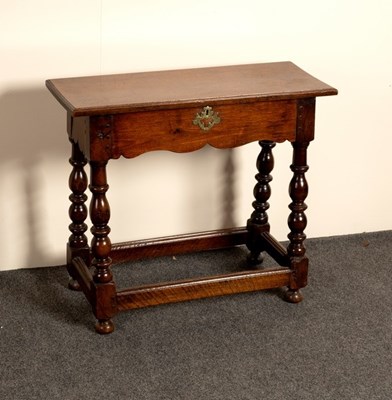 Lot 528 - An oak table with shaped frieze on baluster...