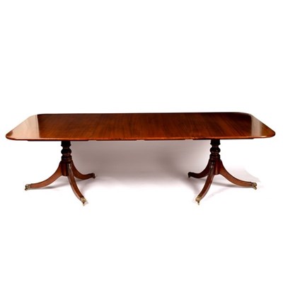 Lot 550 - A mahogany two-pillar dining table, fitted...