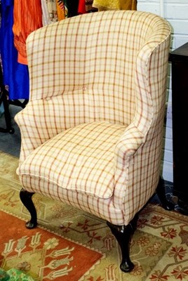 Lot 622 - An upholstered armchair with concave back on...