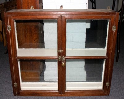 Lot 624 - A small double sided display case enclosed by...