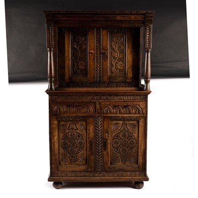 Lot 639 - A carved oak cabinet, the upper and lower...