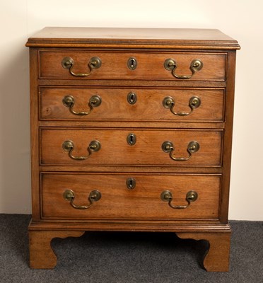 Lot 647 - A narrow mahogany chest of four drawers on...