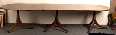 Lot 664 - A mahogany three-pillar dining table,...