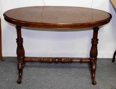 Lot 670 - A Victorian walnut and inlaid oval table on...