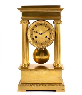 Lot 741 - An Empire ormolu portico clock with four Ionic...