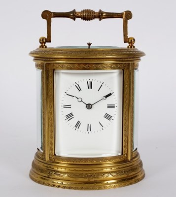 Lot 743 - A gilt brass carriage clock in an oval...