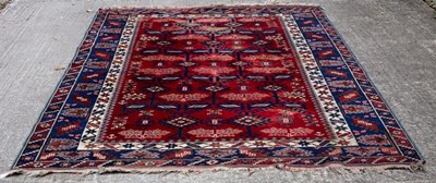 Lot 787 - An Afghan carpet of geometric design to a plum...