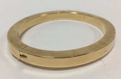 Lot 13 - A Continental gold bangle of flattened...