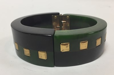 Lot 14 - A Bakelite hinged black and green bangle with...