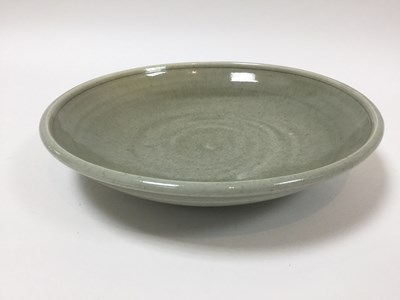 Lot 203 - A celadon glaze stoneware dish, impressed mark...