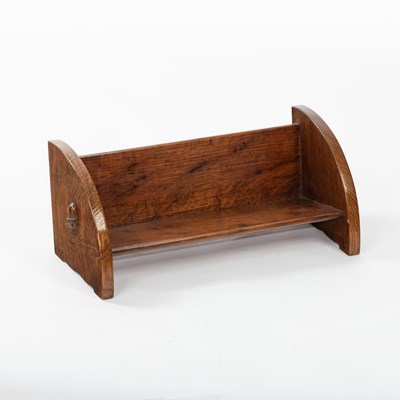 Lot 596 - An Arts & Crafts oak book trough, with carved...