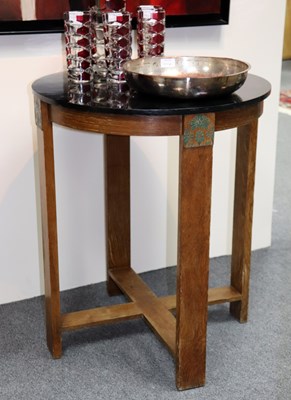 Lot 620 - A circular 1940s oak table, label under for...