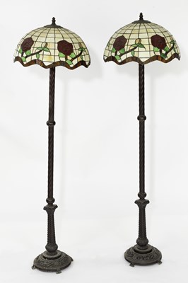 Lot 631 - Style of Tiffany, a pair of metal standard...