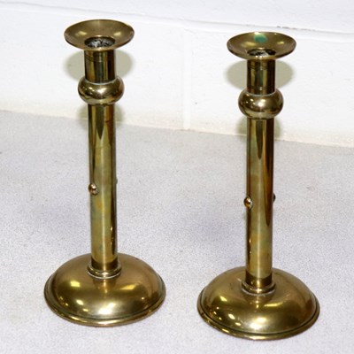 Lot 633 - A pair of Arts & Crafts brass candlesticks, of...