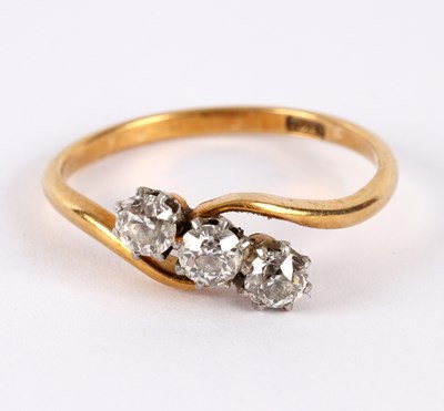 Lot 3 - A three-stone diamond ring, of crossover...