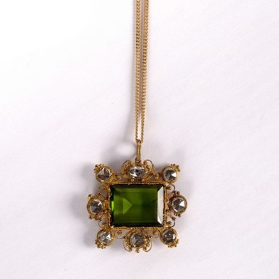 Lot 15 - A tourmaline pendant with border of eight rose...