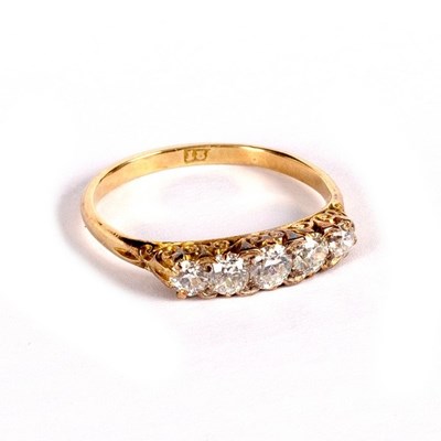 Lot 19 - A diamond five-stone ring in a scroll setting...