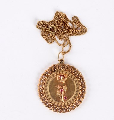 Lot 22 - A 14k gold pendant centred by a gem set flower...