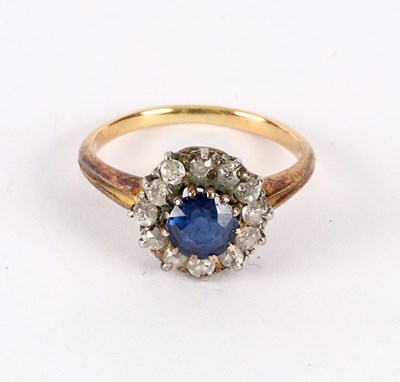 Lot 25 - A sapphire and diamond cluster ring, in a...