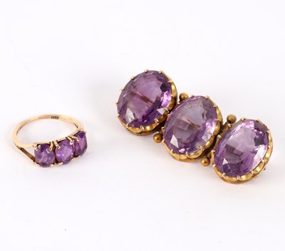 Lot 26 - An amethyst three-stone brooch, the three oval...