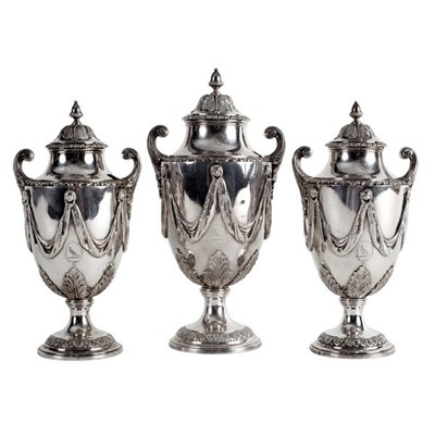 Lot 138 - A garniture of three George III silver sugar...