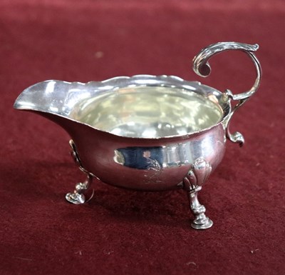 Lot 168 - A George II silver butter boat, London 1750,...