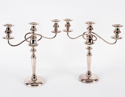 Lot 187 - A pair of silver plated two-branch three-light...