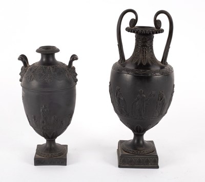 Lot 246 - Two Wedgwood black basalt two-handled urns,...