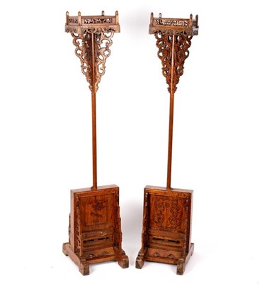 Lot 314 - A pair of Thai candle stands, the top with...