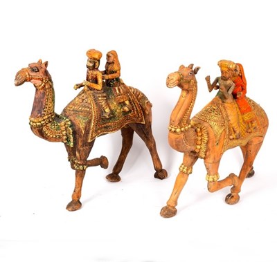 Lot 318 - A carved wood camel with ceremonial harness,...