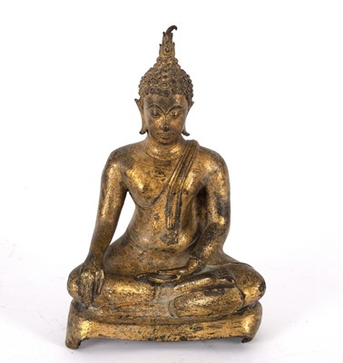 Lot 323 - A small gilded figure of a Buddha seated cross-...