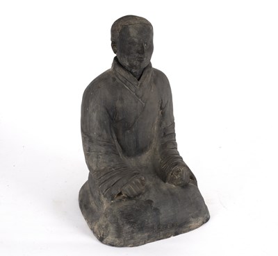 Lot 332 - A black pottery figure of a seated Chinaman...