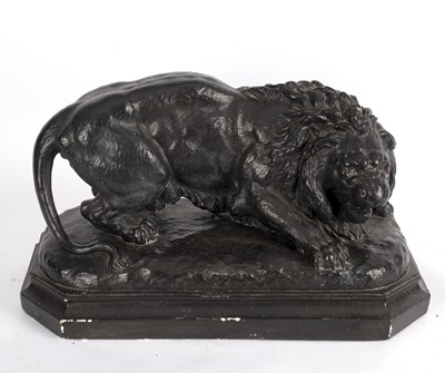 Lot 369 - A blacked plaster figure of a lion, on...