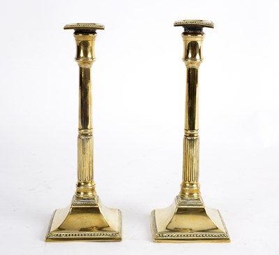 Lot 415 - A pair of brass candlesticks, circa 1790, with...