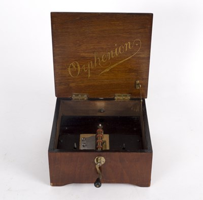 Lot 430 - A wooden cased Orphenion, 23cm wide with four...