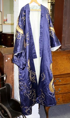 Lot 490 - A Japanese blue silk kimono embroidered in...