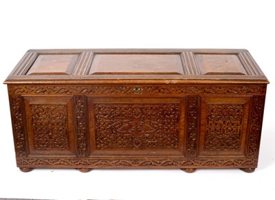 Lot 519 - A carved oak chest with hinged cover, 124cm wide