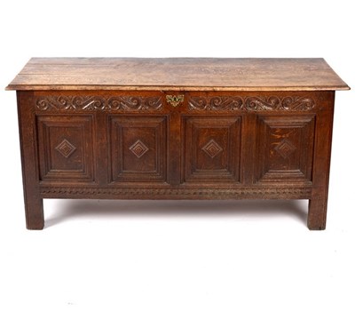 Lot 527 - An oak chest with carved panel front and...