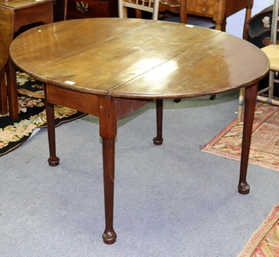 Lot 553 - A George III mahogany two-flap table on round...