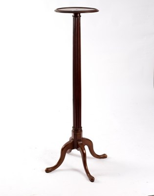 Lot 559 - A mahogany plant pedestal with reeded column...