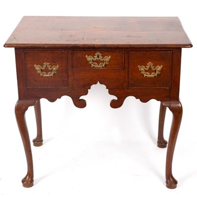 Lot 564 - A George III oak kneehole fitted a surround of...