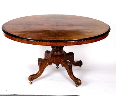 Lot 585 - A Victorian walnut oval table with ebonised...