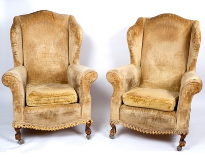 Lot 597 - A pair of wing back armchairs, on claw and...