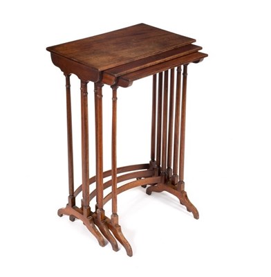 Lot 609 - A nest of three mahogany tables on spindle...